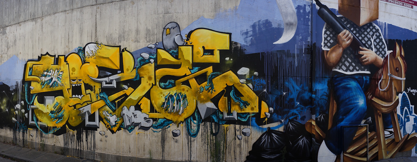 A yellow and blue graffito. Panorama using the Sony NEX-5N and 