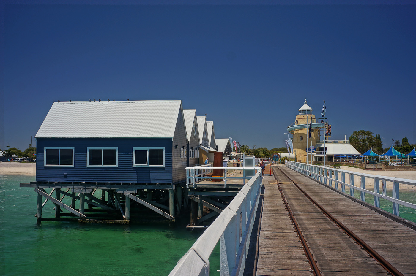 The Busselton Jetty interpretive center with an amusement park in the background
